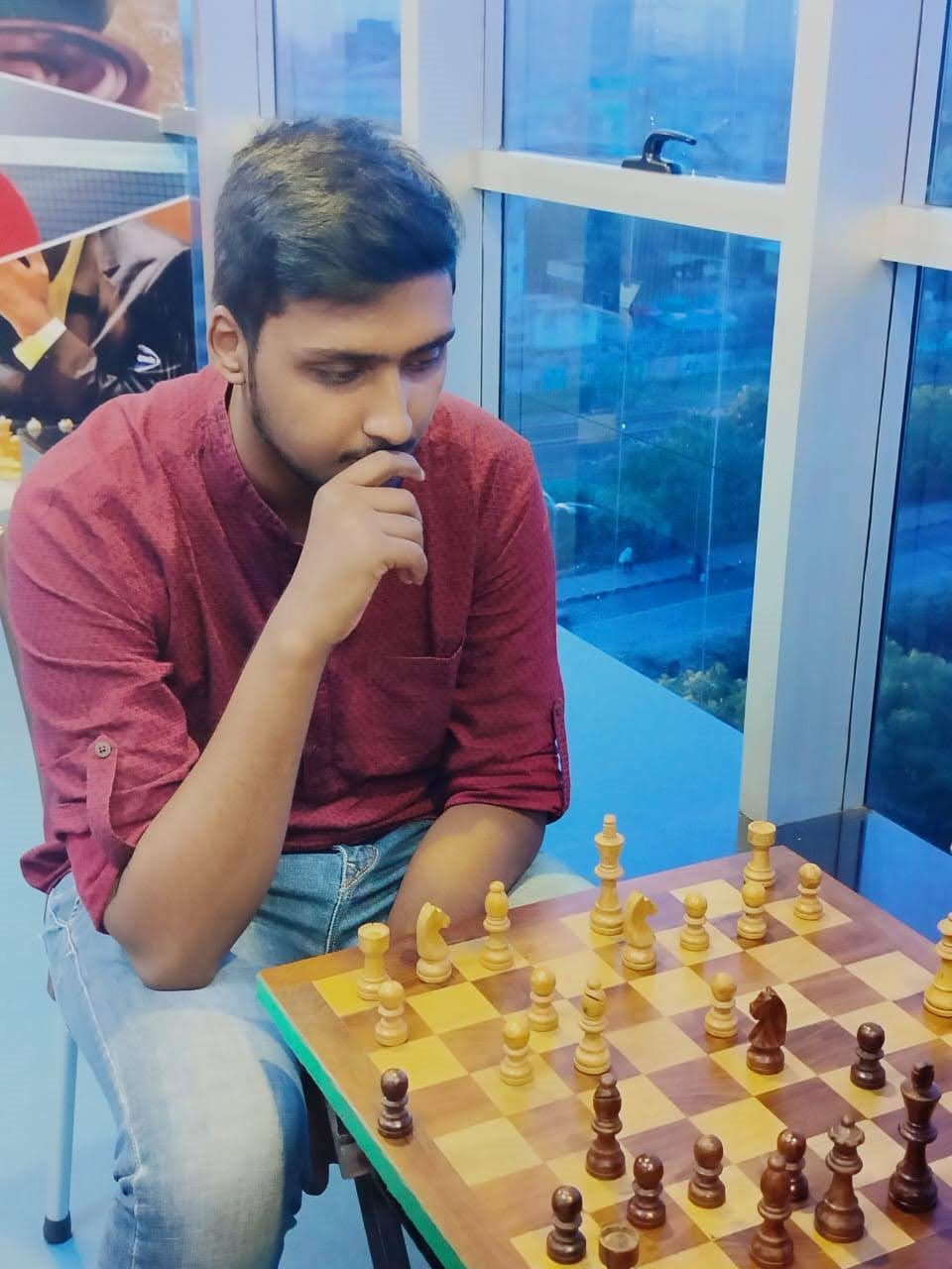 Vishwas Jha playing chess, hand on chin, thinking