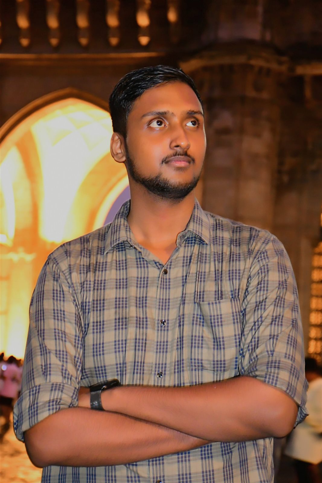 Vishwas Jha in front of a floodlit heritage building in the evening